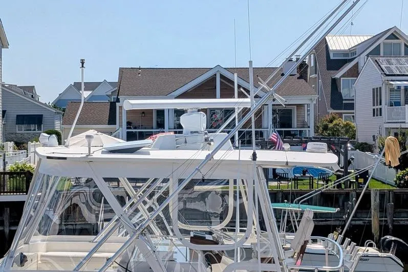 Slide: The Image of 2005 Egg Harbor 43 SportYacht docked near waterfront homes. - 12