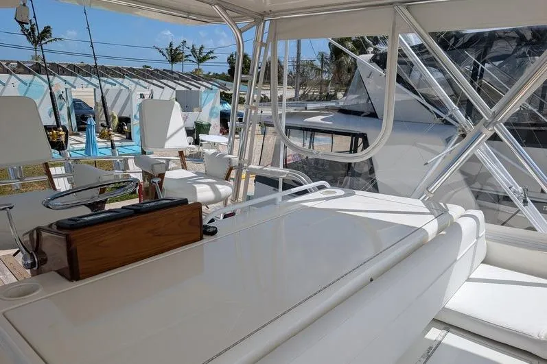 Slide: The Image of 2005 Egg Harbor 43 SportYacht interior with white seating and helm station. - 19
