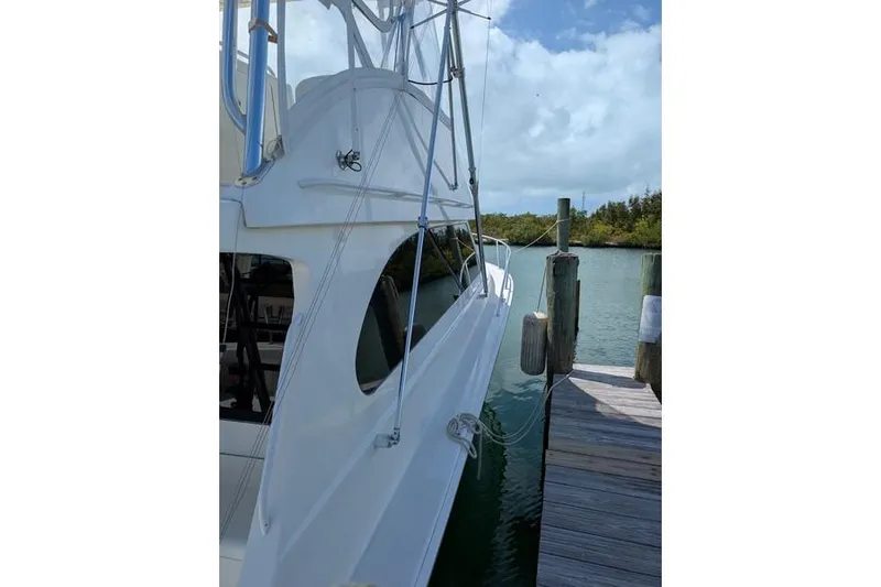 Slide: The Image of 2005 Egg Harbor 43 SportYacht docked by a wooden pier, calm waters in the background. - 21
