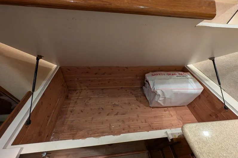 Slide: The Image of Storage compartment in 2005 Egg Harbor 43 SportYacht with safety gear bag. - 23