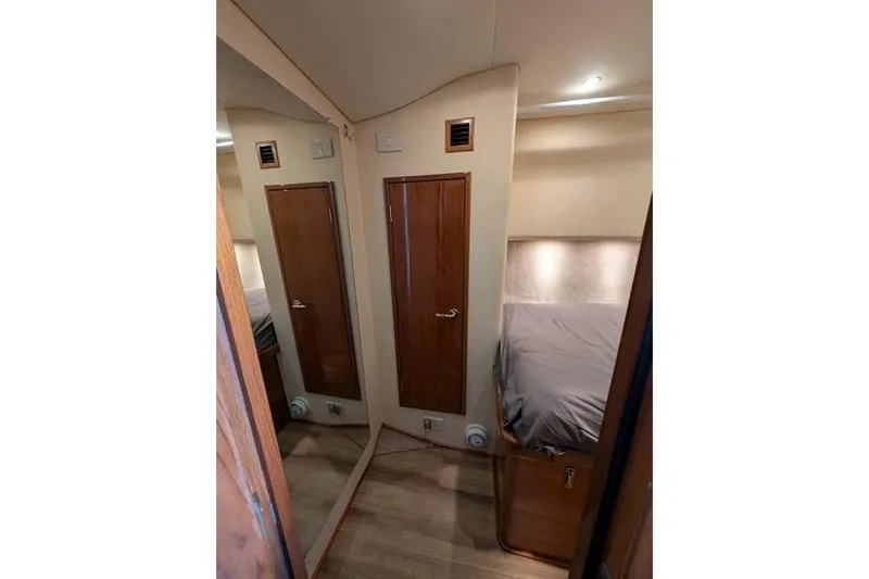Slide: The Image of Interior cabin of 2005 Egg Harbor 43 SportYacht with wooden door and mirrored wall. - 24