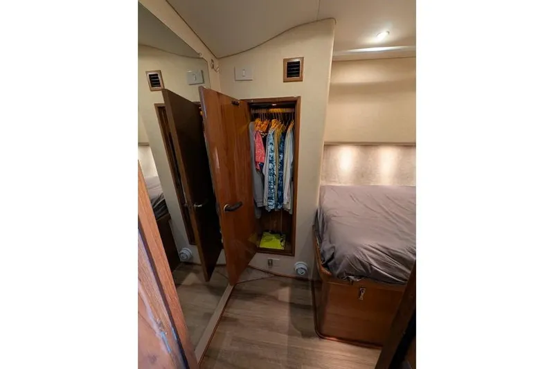 Slide: The Image of Interior of 2005 Egg Harbor 43 SportYacht with open closet and cozy bed. - 25