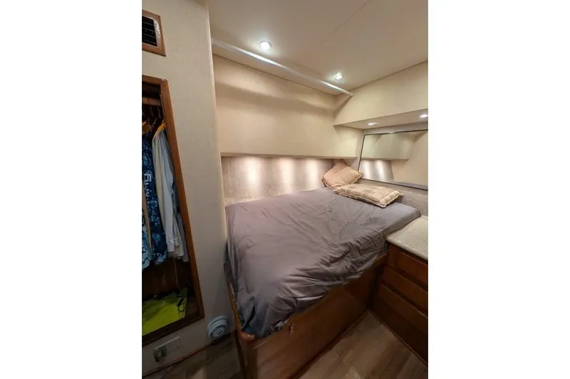 Slide: The Image of 2005 Egg Harbor 43 SportYacht cabin with cozy bed and wooden storage. - 26