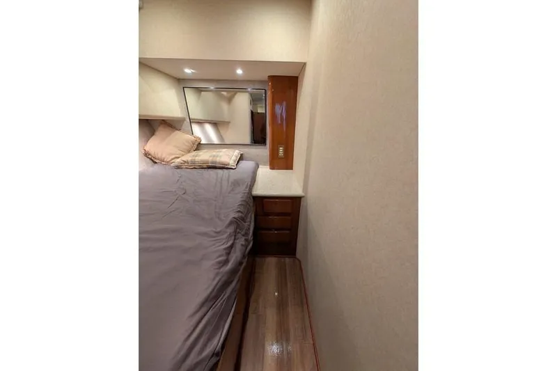 Slide: The Image of Luxurious bedroom interior of 2005 Egg Harbor 43 SportYacht with cozy bedding and wooden accents. - 28