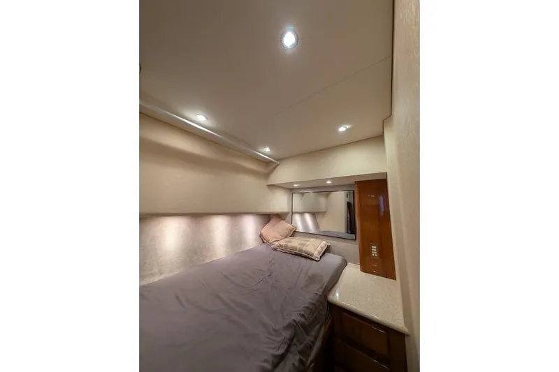Slide: The Image of Luxurious cabin interior of 2005 Egg Harbor 43 SportYacht with cozy bedding and ambient lighting. - 29