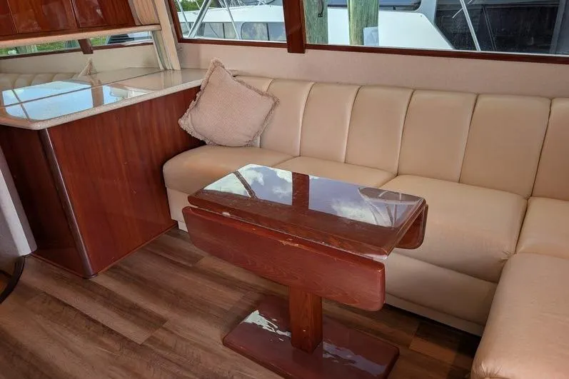 Slide: The Image of Luxurious interior of 2005 Egg Harbor 43 SportYacht with beige seating and wooden table. - 31