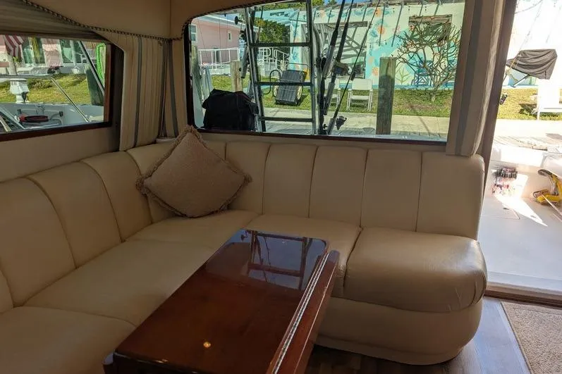Slide: The Image of Luxurious interior of a 2005 Egg Harbor 43 SportYacht with beige seating and wooden table. - 32