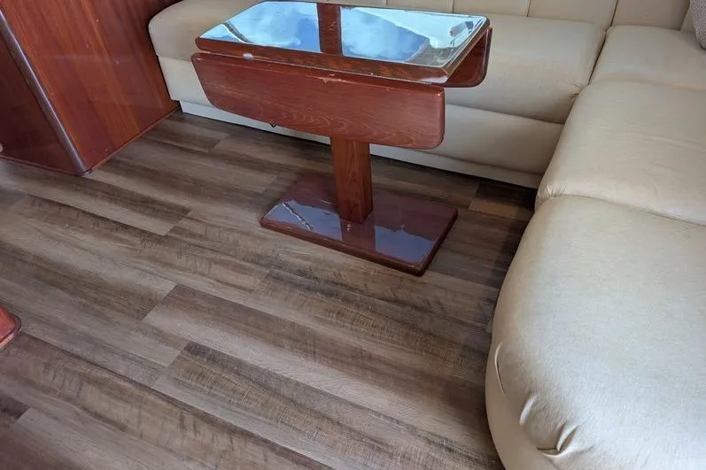Slide: The Image of Interior of 2005 Egg Harbor 43 SportYacht with wooden table and beige seating. - 33