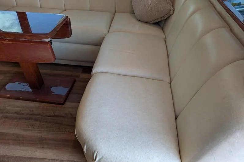 Slide: The Image of Luxurious beige seating and wooden table inside 2005 Egg Harbor 43 SportYacht. - 37