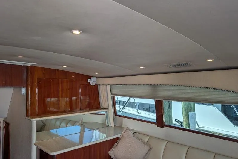 Slide: The Image of Interior of 2005 Egg Harbor 43 SportYacht with elegant seating and wooden accents. - 39