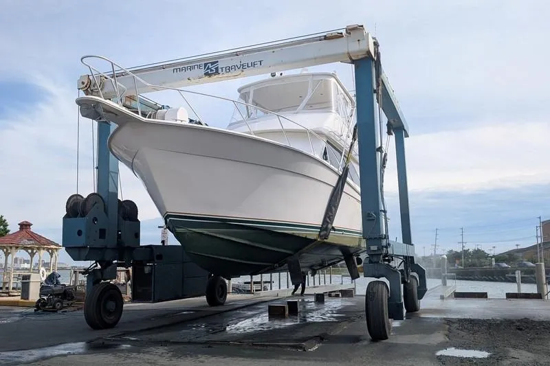 Slide: The Image of 2005 Egg Harbor 43 SportYacht on a marine travel lift at a dockyard. - 4