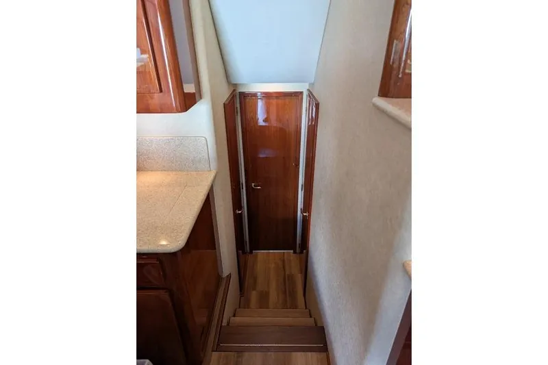 Slide: The Image of Interior view of 2005 Egg Harbor 43 SportYacht, featuring wooden stairs and door. - 40