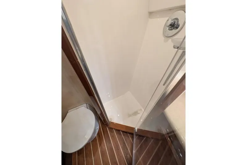 Slide: The Image of Shower area in 2005 Egg Harbor 43 SportYacht with wooden flooring and glass door. - 48