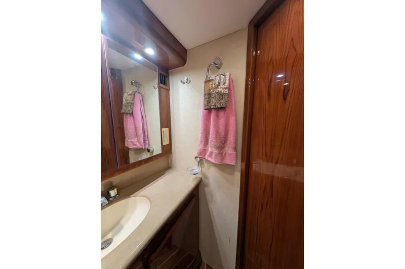 Slide: The Image of Bathroom interior of 2005 Egg Harbor 43 SportYacht with wooden cabinetry and pink towel. - 49