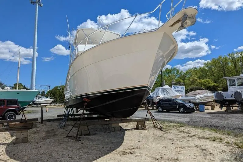Slide: The Image of 2005 Egg Harbor 43 SportYacht on stands at a boatyard under a blue sky. - 5