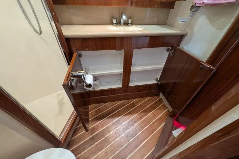 Slide: The Image of Bathroom interior of 2005 Egg Harbor 43 SportYacht with open wooden cabinets. - 52