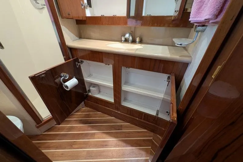Slide: The Image of Bathroom interior of 2005 Egg Harbor 43 SportYacht with open wooden cabinets. - 53