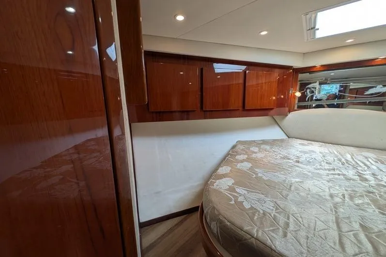 Slide: The Image of Luxurious cabin interior of 2005 Egg Harbor 43 SportYacht with wood paneling and cozy bed. - 57