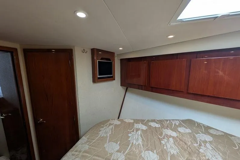Slide: The Image of Luxurious cabin interior of 2005 Egg Harbor 43 SportYacht with wood paneling and cozy bedding. - 59
