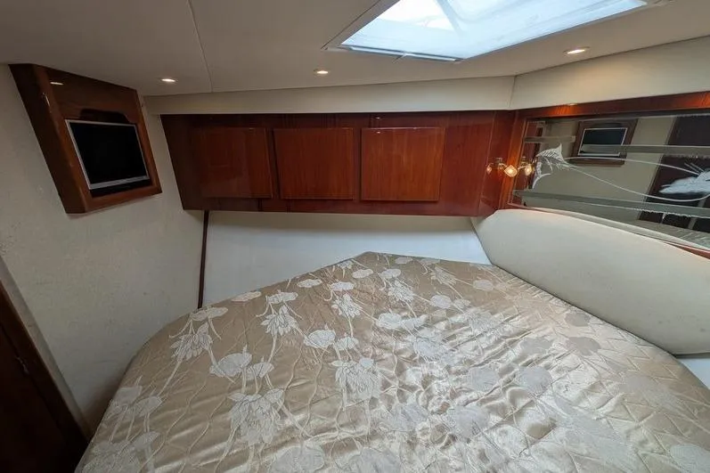 Slide: The Image of Luxurious cabin interior of 2005 Egg Harbor 43 SportYacht with elegant bedding and wood cabinetry. - 60