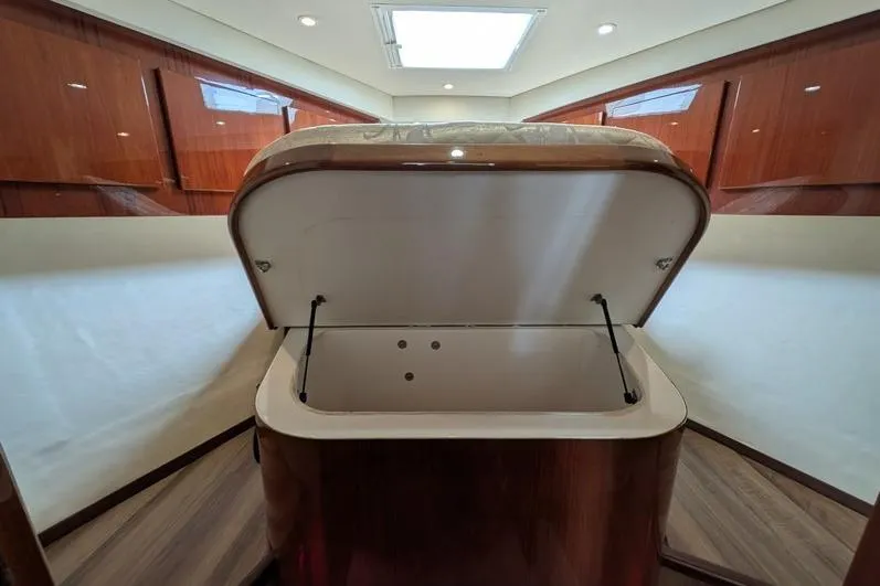 Slide: The Image of Interior of 2005 Egg Harbor 43 SportYacht with open storage compartment, wood finish. - 64