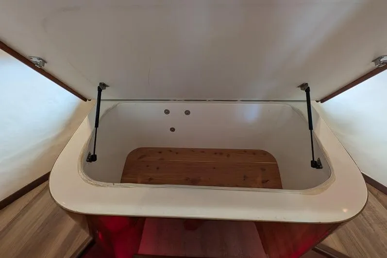 Slide: The Image of Open storage compartment on 2005 Egg Harbor 43 SportYacht with wooden interior. - 65