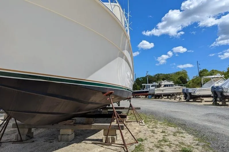 Slide: The Image of 2005 Egg Harbor 43 SportYacht on dry dock under a clear blue sky. - 7
