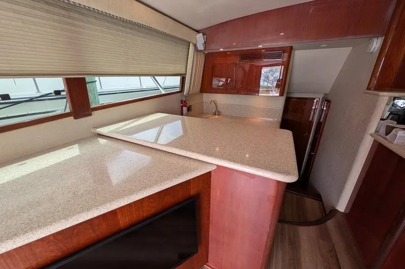 Slide: The Image of Interior of 2005 Egg Harbor 43 SportYacht with sleek countertops and wooden cabinetry. - 70