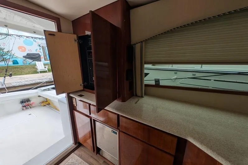 Slide: The Image of Interior of 2005 Egg Harbor 43 SportYacht with open cabinet and view of deck. - 74