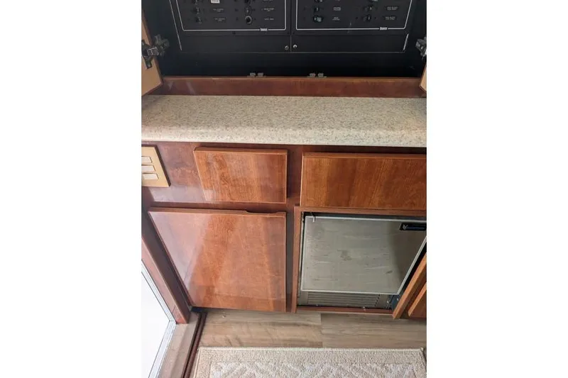 Slide: The Image of Interior view of 2005 Egg Harbor 43 SportYacht with wooden cabinetry and mini fridge. - 76