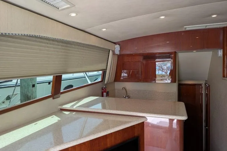 Slide: The Image of Interior of 2005 Egg Harbor 43 SportYacht with sleek countertops and wooden cabinetry. - 79