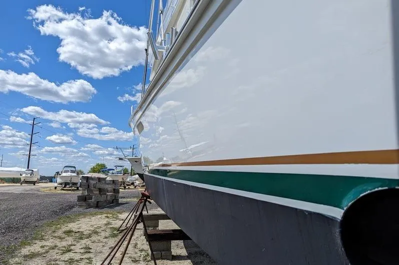 Slide: The Image of 2005 Egg Harbor 43 SportYacht on dry dock under a bright blue sky. - 8