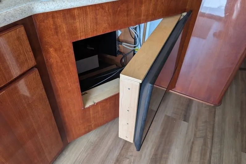 Slide: The Image of Open cabinet with hidden TV in 2005 Egg Harbor 43 SportYacht interior. - 80