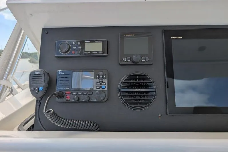Slide: The Image of Control panel of a 2005 Egg Harbor 43 SportYacht with navigation and communication equipment. - 83