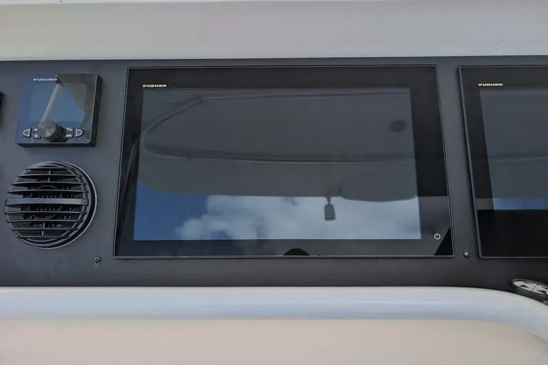 Slide: The Image of Control panel of a 2005 Egg Harbor 43 SportYacht with Furuno displays and speaker. - 84