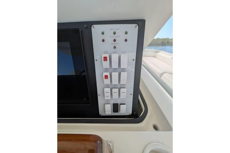 Slide: The Image of Control panel on a 2005 Egg Harbor 43 SportYacht, featuring switches and indicators. - 86