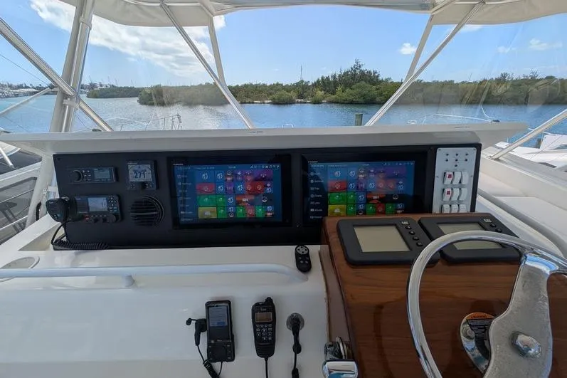 Slide: The Image of Helm of 2005 Egg Harbor 43 SportYacht with navigation screens and controls. - 89