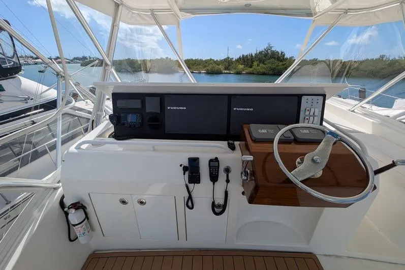 Slide: The Image of Helm of 2005 Egg Harbor 43 SportYacht with navigation equipment and steering wheel. - 94