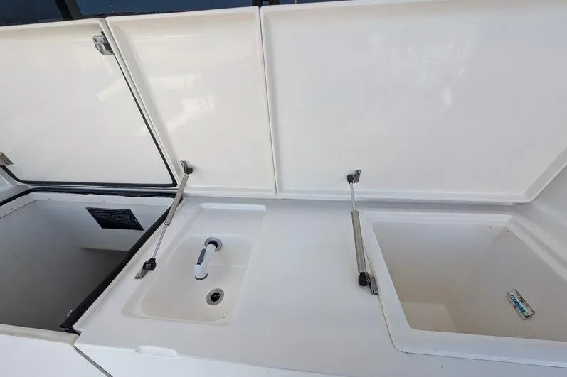Slide: The Image of 2005 Egg Harbor 43 SportYacht sink and storage compartments on deck. - 99