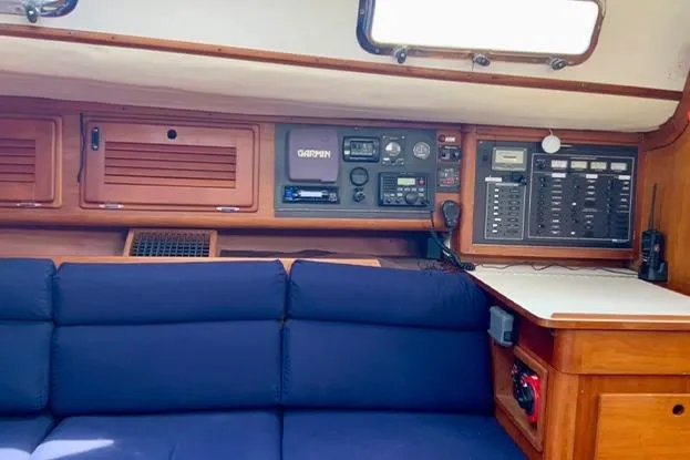 Slide: The Image of Interior of a 1995 Freedom 35 sailboat with navigation equipment and blue seating. - 10