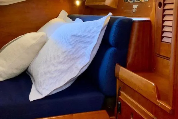 Slide: The Image of Cozy cabin interior of 1995 Freedom 35 sailboat with cushions and wooden finish. - 16