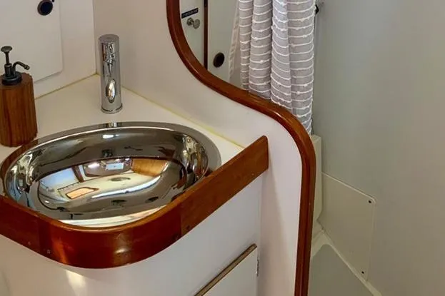 Slide: The Image of 1995 Freedom 35 yacht bathroom with stainless steel sink and wooden accents. - 17