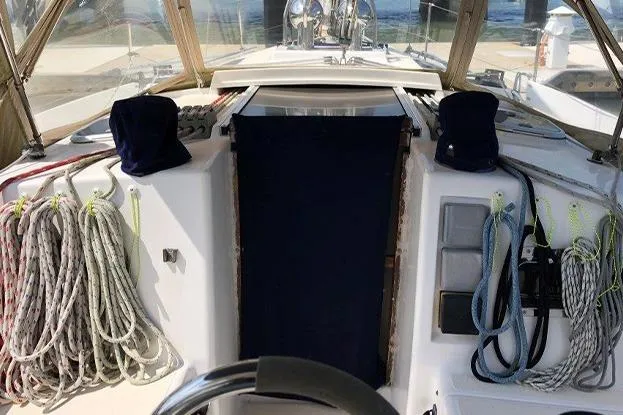 Slide: The Image of Cockpit of a 1995 Freedom 35 sailboat with neatly coiled ropes and covered instruments. - 6