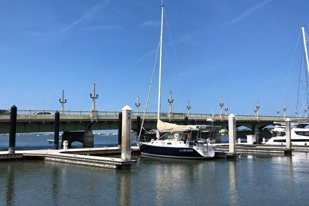 Slide: The Image of Sailboat Freedom 35 (1995) docked near a bridge on a sunny day. - 7