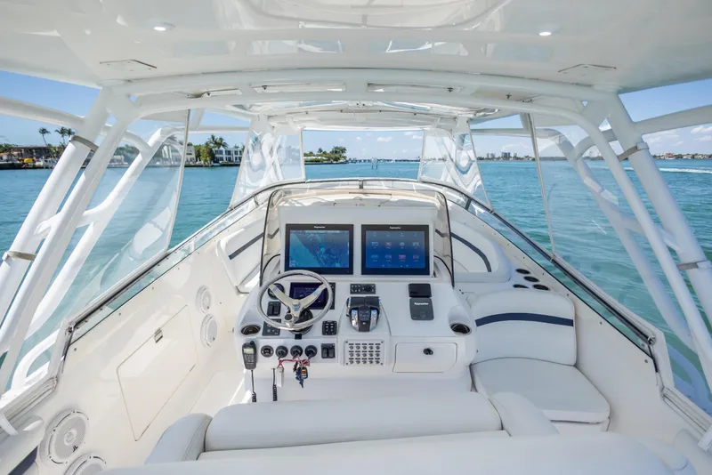 Slide: The Image of 2014 Intrepid 400 Cuddy helm with dual screens, steering wheel, and ocean view. - 15