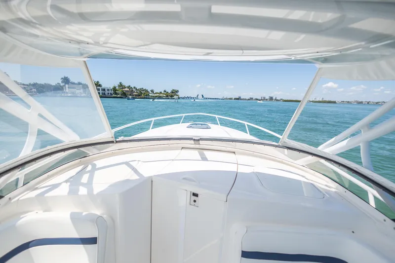 Slide: The Image of 2014 Intrepid 400 Cuddy boat cruising on clear blue waters. - 19