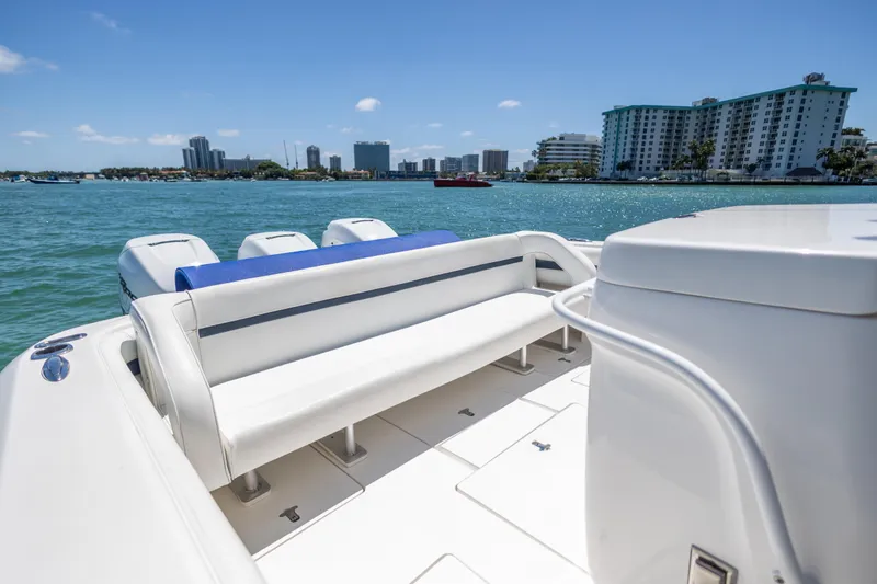 Slide: The Image of 2014 Intrepid 400 Cuddy boat with seating, ocean view, and city skyline in background. - 23
