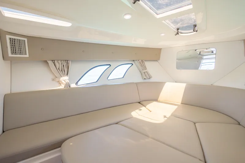 Slide: The Image of Interior of 2014 Intrepid 400 Cuddy boat with beige seating and windows. - 29