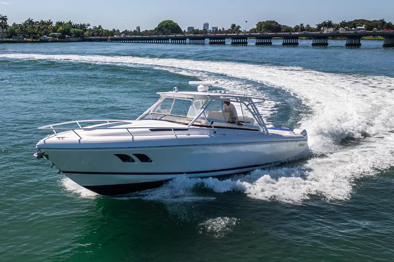 Slide: The Image of 2014 Intrepid 400 Cuddy cruising on open water with scenic background. - 3