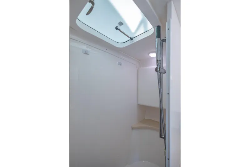 Slide: The Image of 2014 Intrepid 400 Cuddy boat interior shower with skylight and modern fixtures. - 33